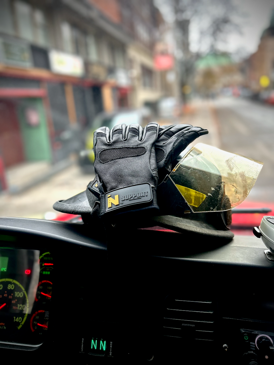 SUPPORT glove and firefighter helmet on truck dash