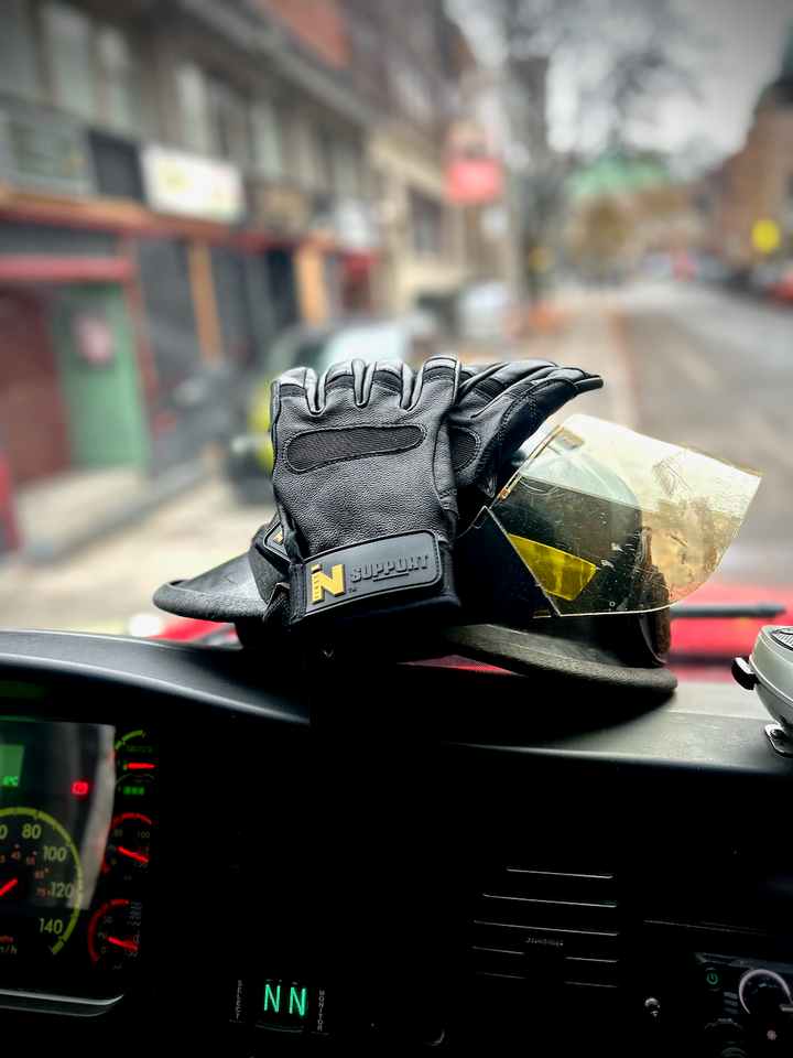 SUPPORT glove and firefighter helmet on truck dash