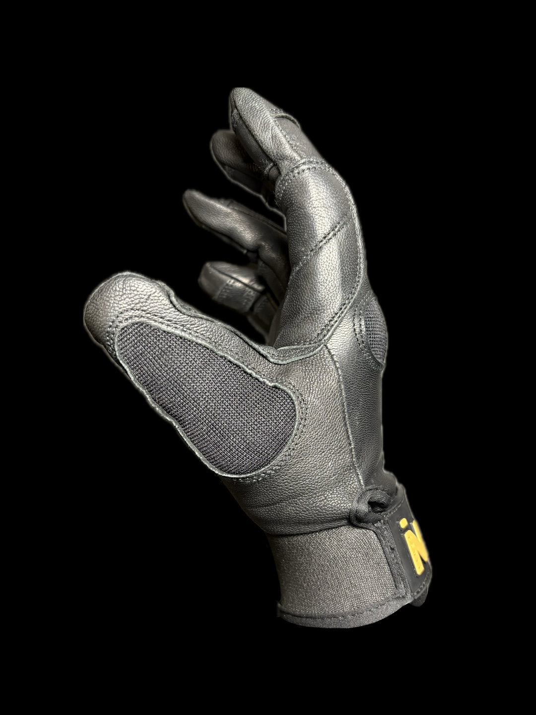 Left side of black utility glove with visible branding on a black background